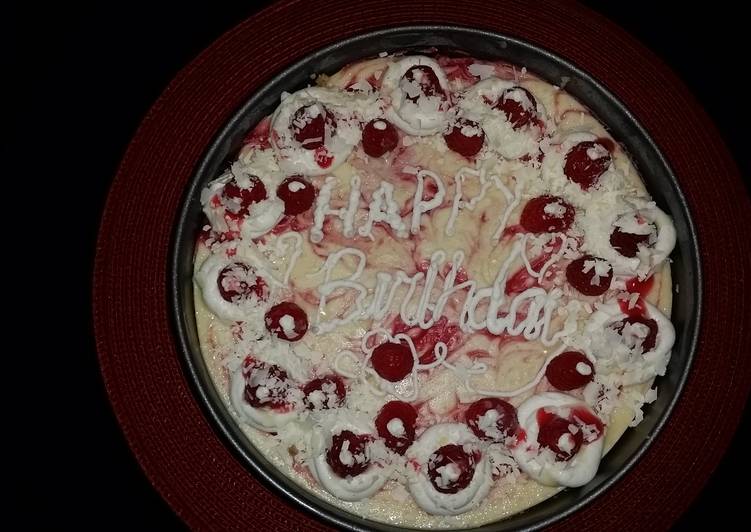 Recipe of Ultimate White chocolate raspberry swirl cheesecake topped with raspberries and sauce