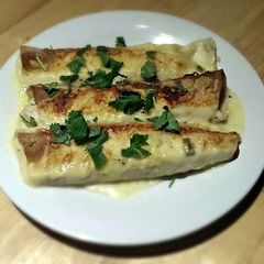 A picture of White Chicken Enchiladas with Green Chile Sour Cream Sauce.