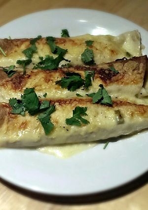 A picture of White Chicken Enchiladas with Green Chile Sour Cream Sauce.
