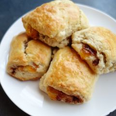 A picture of Scones with cinnamon and apricot jam.