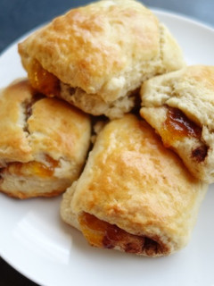 A picture of Scones with cinnamon and apricot jam.