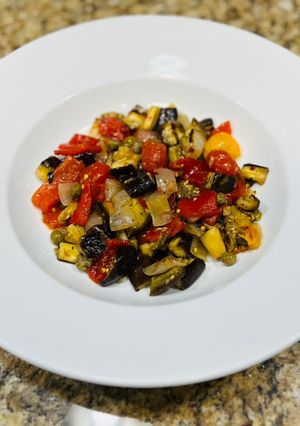 A picture of Roasted eggplant and red pepper salad.