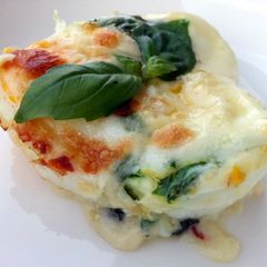 A picture of Baked Cheesy Egg With Basil Sauce.