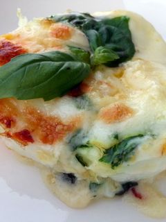 A picture of Baked Cheesy Egg With Basil Sauce.