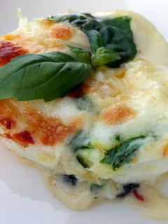 A picture of Baked Cheesy Egg With Basil Sauce.