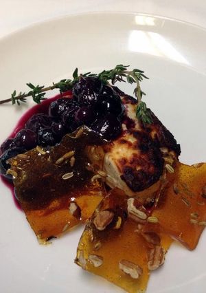 A picture of Roasted feta with Cava, thyme, blueberry compote and glass candy with toasted fennel and pecans.