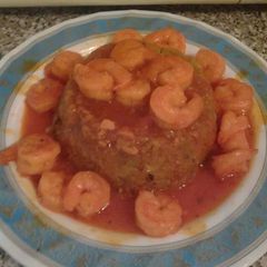 A picture of Mofongo and shrimp in red garlic sauce.