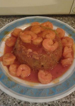 A picture of Mofongo and shrimp in red garlic sauce.