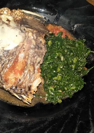 A picture of Stewed fish and greens.