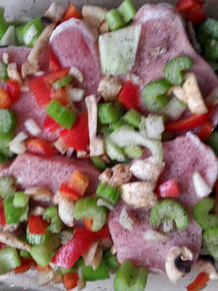 A picture of easy pork chops and veggies in a pan.