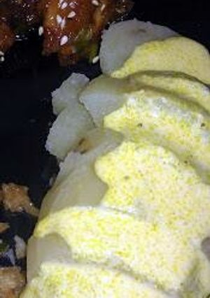 A picture of papa a la huancaina (peruvian potatoes with a curry cheese sauce.