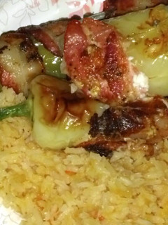 A picture of Bacon Wrapped Sausage & Cheese Stuffed Green Chiles.