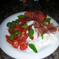 A picture of Caprese Salad w Sicilian Olives & Prosciutto.