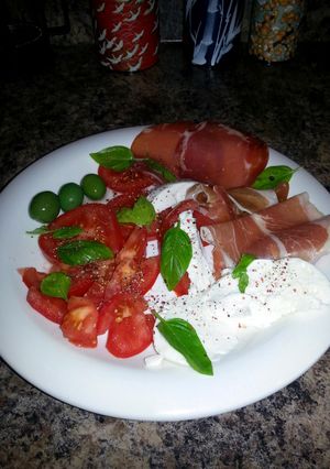 A picture of Caprese Salad w Sicilian Olives & Prosciutto.