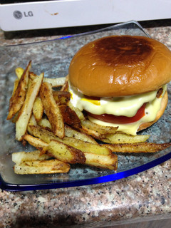 A picture of Extra Cheese Burger And Home Made Fries.
