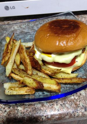 A picture of Extra Cheese Burger And Home Made Fries.