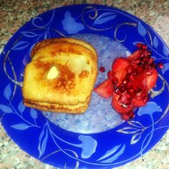 A picture of Cinnamon French toast with strawberry and penetrant salad.