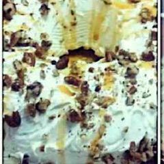 A picture of Butter Pecan Cake with Cream Cheese Icing & Caramel Drizzle.
