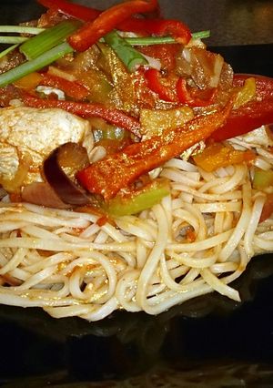 A picture of Chinese chicken stir fry with egg noodles.