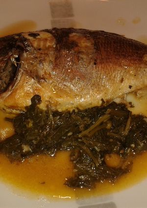 A picture of Sea Bass with spinach and white wine.