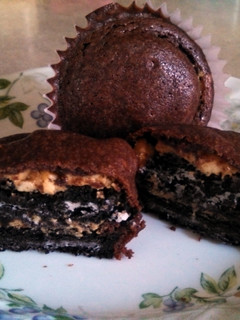 A picture of Brownie cupcakes with peanut butter Oreo centers.