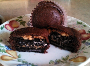 A picture of Brownie cupcakes with peanut butter Oreo centers.