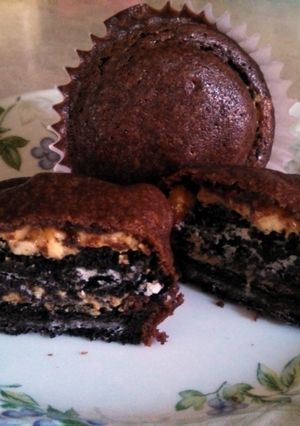 A picture of Brownie cupcakes with peanut butter Oreo centers.