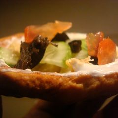 A picture of Seven layer dip in bread bowls.