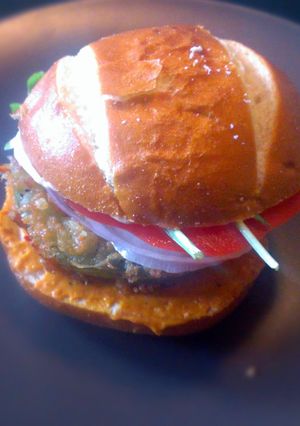 A picture of Fried Green Tomatillo Sandwich with Parsnip Fries.