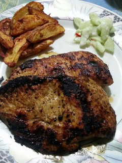 A picture of Cajun Chicken with Chilli Potatoes and Cucumber Salad.