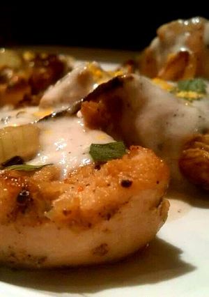 A picture of Marinated chicken with white cheesy sauce..