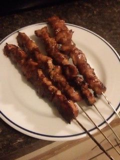 A picture of Pork kebabs on the grill.