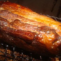 A picture of Homemade Bacon Smoked with Barley Tea in a Pot.
