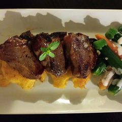 A picture of Orange mint Glazed Lamb Loins Fresh Summer Veggies and Creamy L.