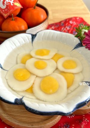 A picture of Egg Yolk Mochi Dumplings in Ginger Syrup.