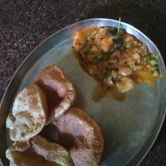 A picture of Poori with potato peas gravy.