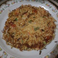 A picture of Noodle cake on pan.