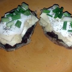 A picture of hamburger stuffed potato skins.
