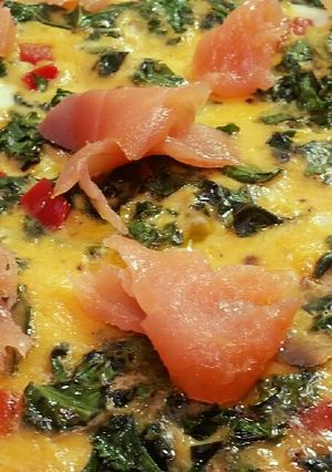 A picture of Omelette with salmon, red capsicum and kale.