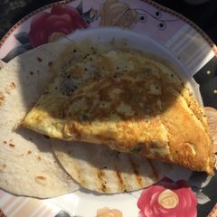 A picture of 3 Egg Omelette Served On A Tortilla Wrap.