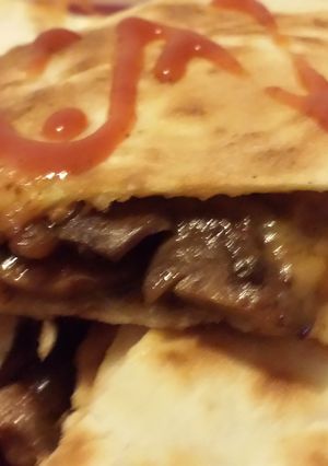 A picture of Cheesy steak and mushroom Quesadilla.