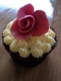 Indugant chocolate muffins with a vanilla bean butter cream topped with a homemade rose