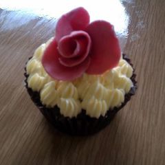 A picture of Indugant chocolate muffins with a vanilla bean butter cream topped with a homemade rose.