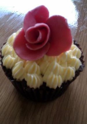 A picture of Indugant chocolate muffins with a vanilla bean butter cream topped with a homemade rose.