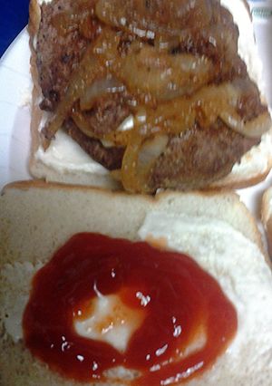 A picture of sirloin burgers with caramelized onions.