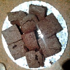 A picture of Chewy brownies with cocoa powder.