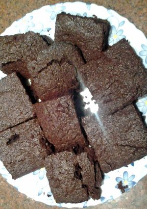 A picture of Chewy brownies with cocoa powder.