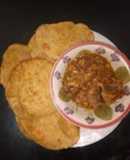 Homemade gurasa with chicken sauce