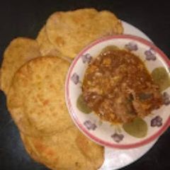 A picture of Homemade gurasa with chicken sauce.