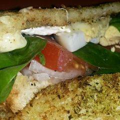 A picture of Sig's Goats Brie, Egg and Tomato griddle Sandwich.